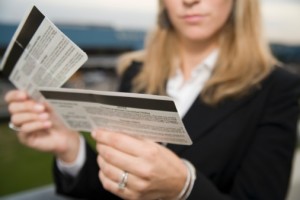 73097066-woman-reading-airplane-ticket-gettyimages