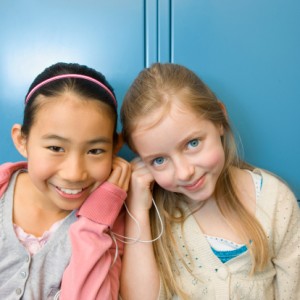 88621606-girls-listening-to-mp3-player-in-school-gettyimages