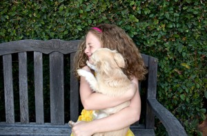 148984029-girl-sitting-with-kissing-dog-gettyimages